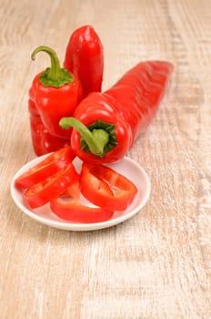 Red fresh paprika on a wooden table