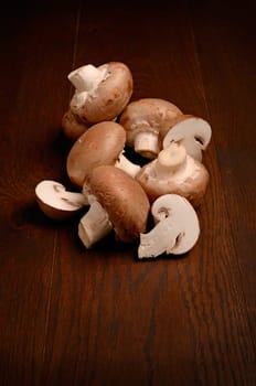 Brown mushrooms on a rustic wooden background