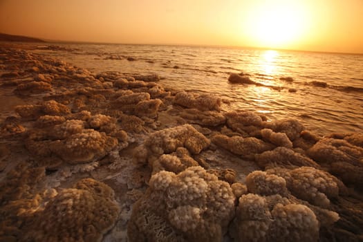 The coast with natural salt of the death sea neat the Village of Mazraa in Jordan in the middle east.