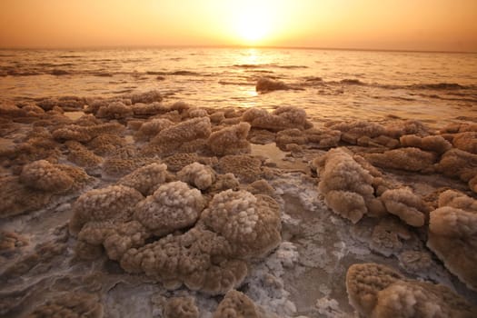 The coast with natural salt of the death sea neat the Village of Mazraa in Jordan in the middle east.
