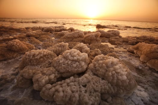 The coast with natural salt of the death sea neat the Village of Mazraa in Jordan in the middle east.