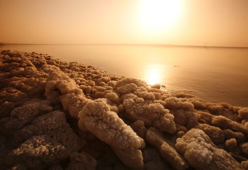 The coast with natural salt of the death sea neat the Village of Mazraa in Jordan in the middle east.