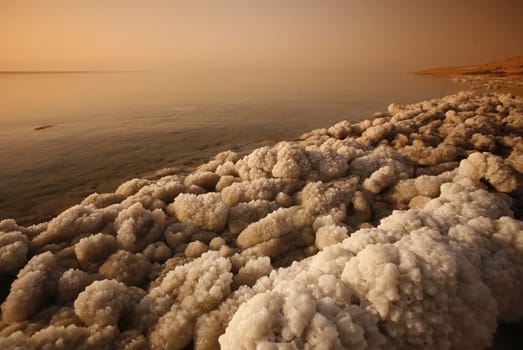 The coast with natural salt of the death sea neat the Village of Mazraa in Jordan in the middle east.