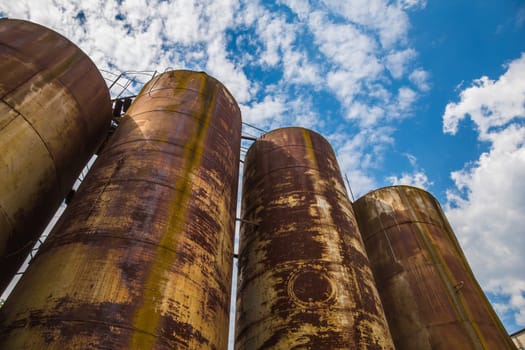 Big old deserted rusty tanks