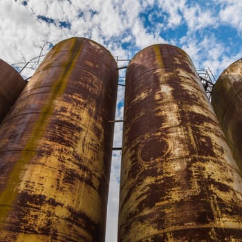 Big old deserted rusty tanks