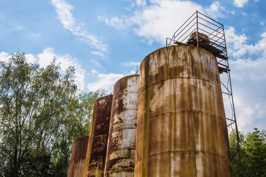 Big old deserted rusty tanks