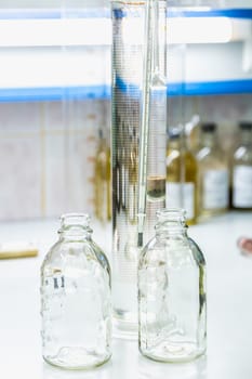 Empty glass bottles on table. Research laboratory glassware