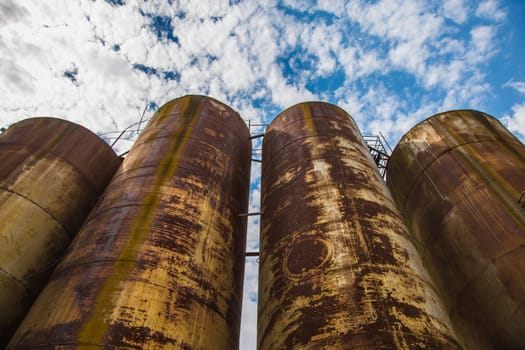 Big old deserted rusty tanks