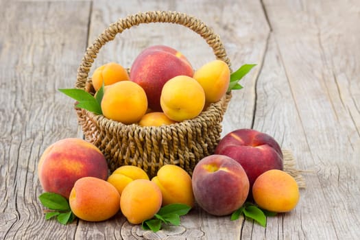 fresh fruits in a basket on wooden background
