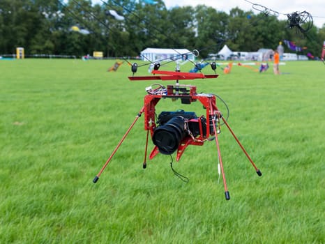 camera hanging under a kite for taking aerial pictures