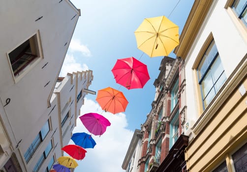 colorful umbrellas in the streets of Deventer, netherlands during "Deventer on stilts"", one of the most prestigious outdoor theatre festivals in the country"
