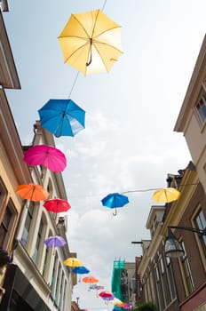 colorful umbrellas in the streets of Deventer, netherlands during "Deventer on stilts"", one of the most prestigious outdoor theatre festivals in the country"