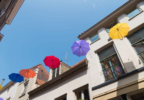 colorful umbrellas in the streets of Deventer, netherlands during "Deventer on stilts"", one of the most prestigious outdoor theatre festivals in the country"