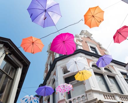 colorful umbrellas in the streets of Deventer, netherlands during "Deventer on stilts"", one of the most prestigious outdoor theatre festivals in the country"