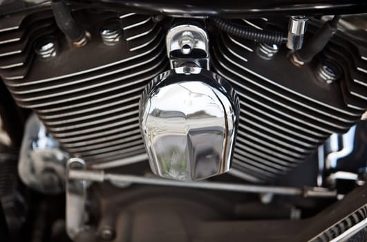 Close up of an engine of a silver shining motorbike