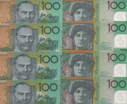 Background of overlapping Australian 100 dollar notes showing the two sides