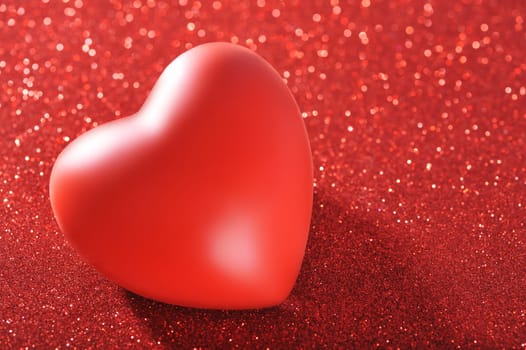 Red heart on red glitter background