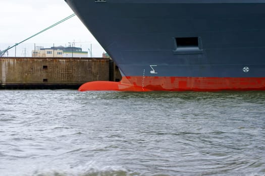 The photograph and side view of the front part of a ship with the bow bead in the water.