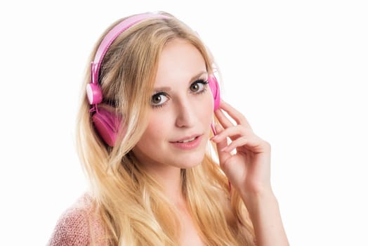 blonde young woman listens to music on the headphones