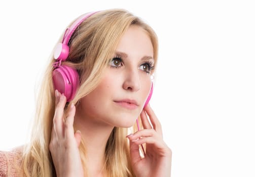 blonde young woman listens to music on the headphones