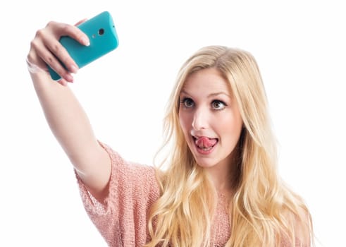 a blonde girl sticks out her tongue and takes a selfie