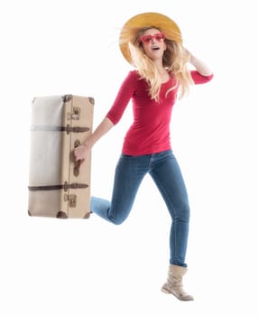 a woman with a summer runs fast and carrying a suitcase in a hand