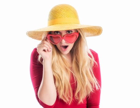 a blonde young woman wears a summer hat and sunglasses