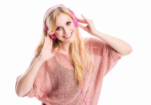 blonde young woman listens to music on the headphones