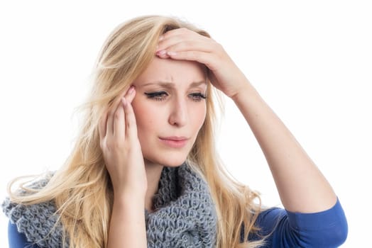 Blonde woman has headaches and grabs her head