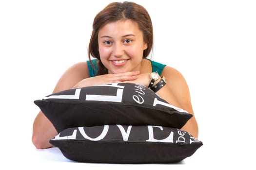 teenage girl lying over pillows on white background