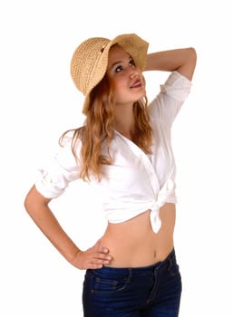 A beautiful young woman in a white blouse, jeans and a straw hat standing.isolated for white background, looking up..