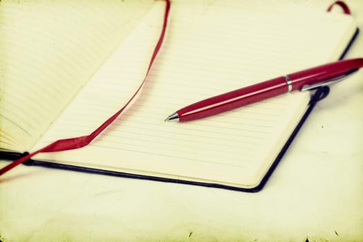 Vintage photo of blank notebook and pen