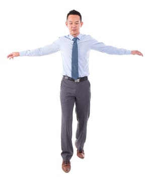 Asian business man walking balance, front view full length isolated over white background.