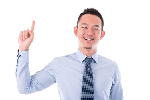 Asian business man smiling and finger pointing up, isolated over white background.