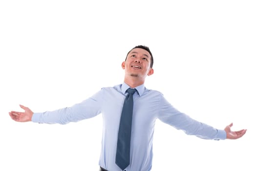 Asian business man open arms outstretched, looking up, isolated over white background.