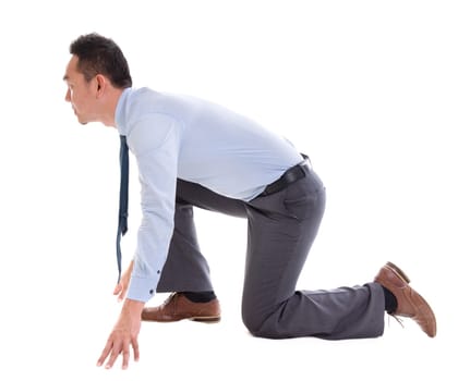 Asian business man on starting line of a race, side view full length isolated over white background.
