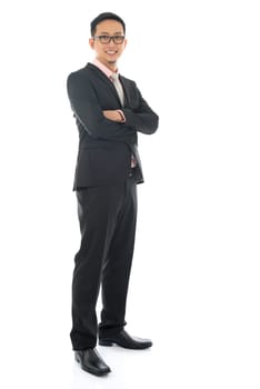 Full length confident southeast Asian business man crossed arms standing isolated on white background.
