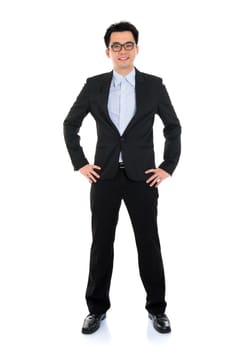 Full length Asian businessman in formal suit standing isolated on white background.