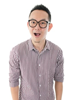Portrait of Asian man looking at camera, shocked and standing isolated on white background.