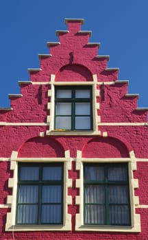 Red gable roof of the historic house (Bruges, Belgium). Front view.