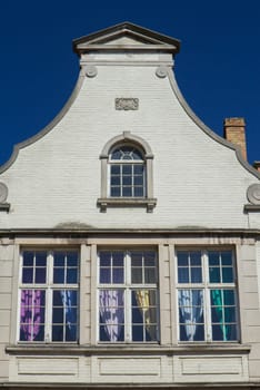 White gable roof of the historic house (Bruges, Belgium). Front view.