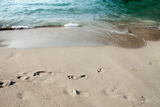 Footsteps in the sand on the beach