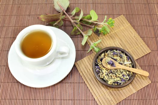 a cup of herbal tea and Chinese herbs