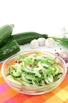 a bowl of cucumber salad with dill and red onions