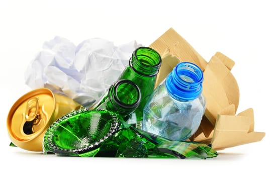 Composition with recyclable garbage consisting of glass, plastic, metal and paper isolated on white background