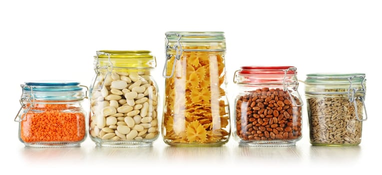 Jars with grain foods isolated on white background