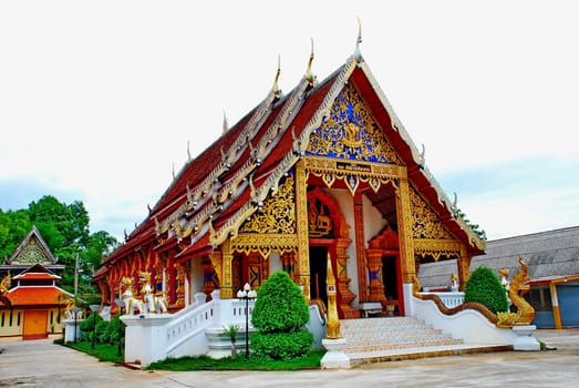 horse carriage and  temple Phrathat Lampang Luang in Lampang, Thailand