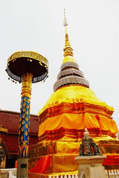 horse carriage and  temple Phrathat Lampang Luang in Lampang, Thailand
