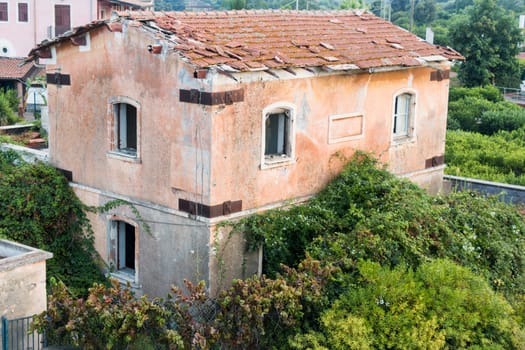 Ruin of old roadhouse with vegetation on it