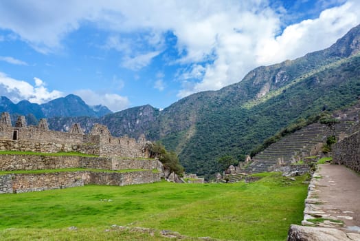 View of the ruins of Machu Picchu with a blue sky visible in the background
